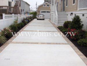 concrete driveway with brick borders