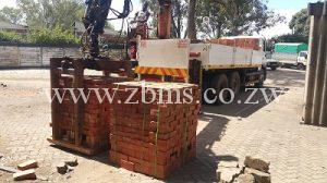 bricks for sale delivery with crane on pallets wrapped and packed